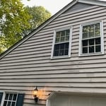 Rotten siding and deteriorated paint.