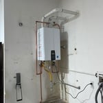 Navien tankless water heater installation with sediment trap expansion tank, and proper exhaust and intake ventilation , up to city codes and regulations