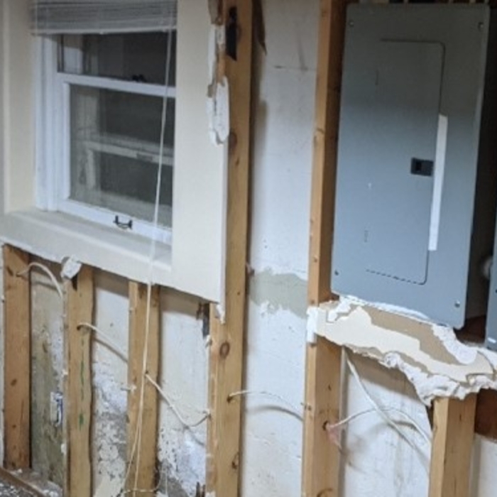 The homeowner's electrical room before the basement waterproofing installation.