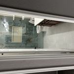 Remodeled guest bathroom with walk-in shower, transition piece shown