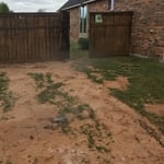 The side yard that was damaged by heavy machinery