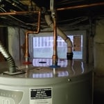 Here we can see the completed project, notice the new water heater, new water shut off valve and new copper piping from the water heater and replacing the gas line somone used as a water line from the previous install.