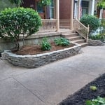House front bed rescue after. Dry stack wall. Gravel border