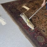 Flushing the dirt out of a rug on the wash floor