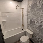 External valve style with tub and shower. ADA height elongated toilet.