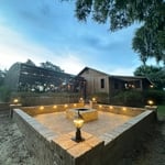 Paver patio with walls, lights and a firepit