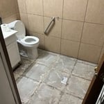 Damaged subfloor from improper tile install that was replaced for new vinyl flooring.