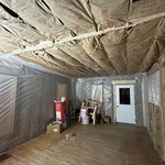 New carrying beam mounted flush into the ceiling with the insulation and poly in the walls to minimize heat loss