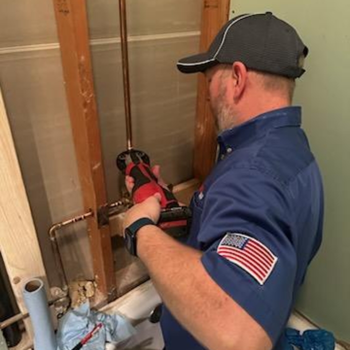 Paul using a Pro Press to connect copper connections.