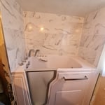 Walk-in tub with new tile surround.