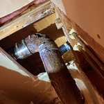 Corroded cast iron fittings led to discharge coming out of fitting through hole seen in picture.