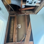 Bathroom wall and ceiling affected by roof leak.