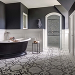View from entry door. Black free-standing tub and tiled shower. Patterned porcelain tile floor.