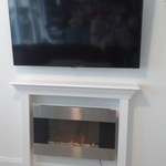 Title fireplace mantle with an electric fireplace