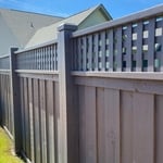 6’ tall capped privacy, board-on-board, lattice top specialty fence with Harbor Mist stain built by Summit Fence in Powder Springs