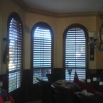 Arched Plantation Shutters in Mahogany stain