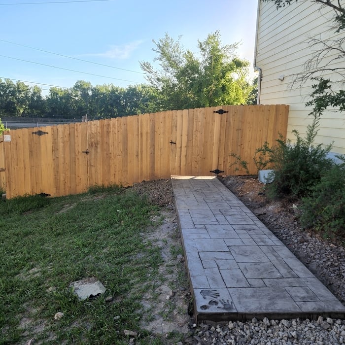 Fencing, stamped patios, metal railing, and covered structure