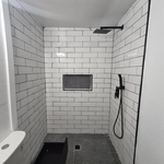 We completed this bathroom by adding new shower tile, tile floor, new vanity and a cover wall.