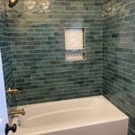tialed tub surround and around the toilet