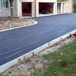 Asphalt driveway with concrete ribbons