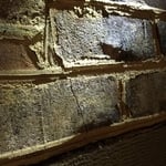 Cracks were spreading down the wall
