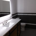 tiled wall, floor and rear lit mirror