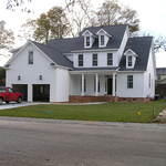 Colonial home with high pitch roof and white siding
