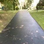 Repave section and sealcoat over existing driveway