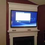 TV mounted over fireplace.