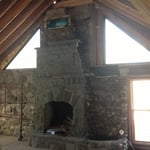 Water fall on the side of a fireplace.