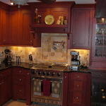 beautiful customized kitchen with dark red cabinets