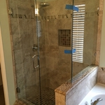 Frameless shower enclosure