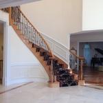 elegant curved staircase with ornate wrought iron rails