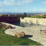 Transitional Pool - Gray Lush Water Features Comes Out From Stone Partition Wall Into Pool