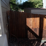 Fence being power washed