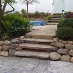 boulder retaining wall with stair inlay