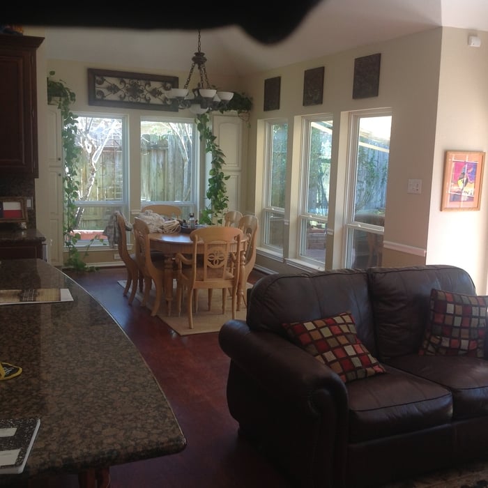 an open floor plan view of a family room and open dining room