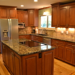 traditional kitchen with medium stained wood cabinets and tile backsplash