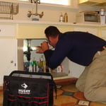Inspecting kitchen plumbing