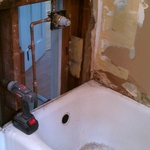 gutted walls and plumbing and made tile ready