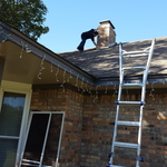 Inspecting roof and chimney flashing