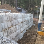 large concrete block wall with rock face design
