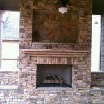 Stack stone fireplace, patio, and gas logs
