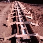 Holes dug with concrete forms in place