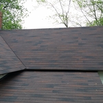 Traditional home exterior with brown asphalt shingled roof