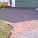 asphalt driveway with paver border and apron