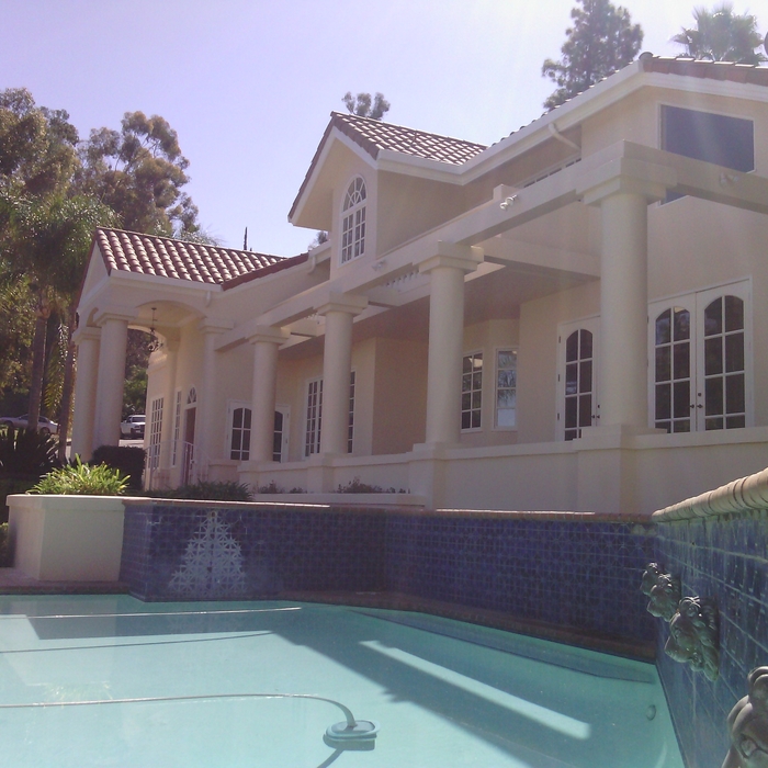 Mediterranean pool with blue tile and lion fountains
