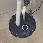 Sump lid fastened to sump crock above floor