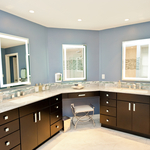 Modern bathroom with dark flat front cabinetry, quartz countertops, and blue wall paint