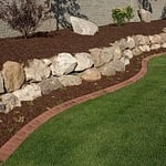 Double Shredded Hardwood Mulch & Boulder wall